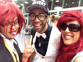 Mya at ACen 2015, cosplaying as Grell Sutcliff from  Black Butler, with cosplay icons Panda & Lux